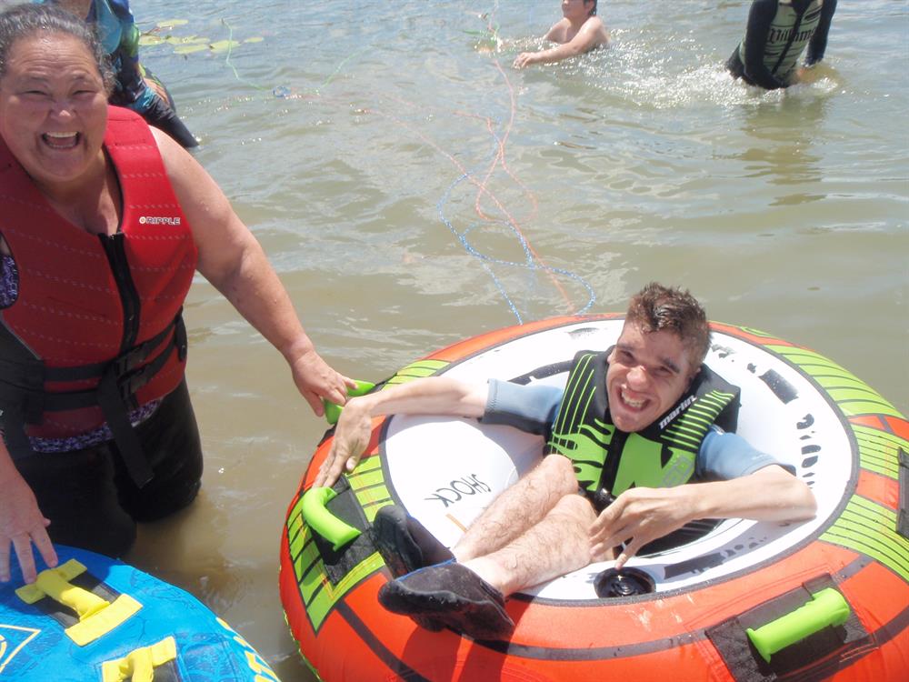 Man with disability in tube in water