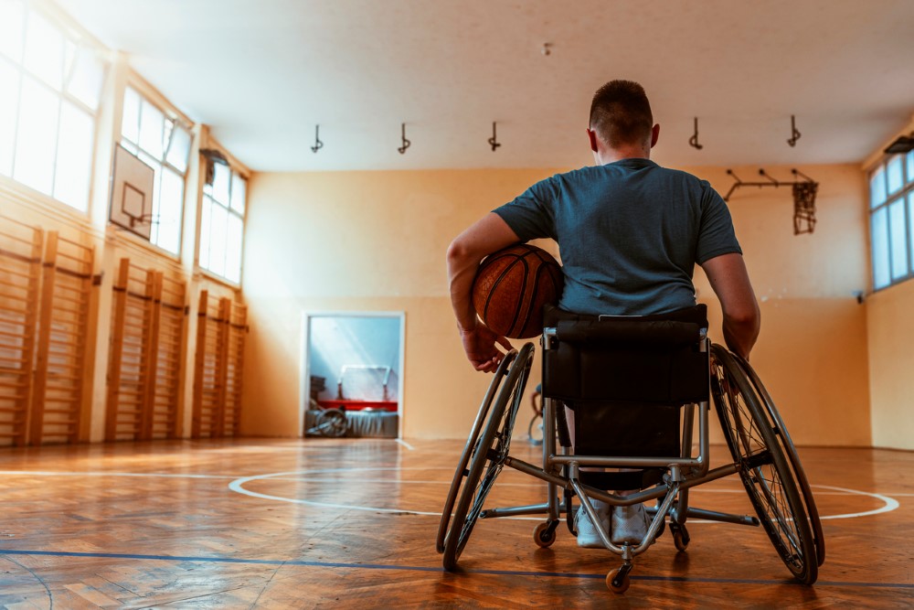 Boy in a wheelchair with a basketball