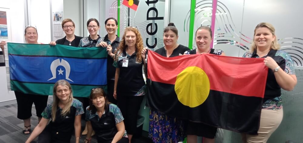 Feros Care staff with Aboriginal and Torres Strait Islander flags
