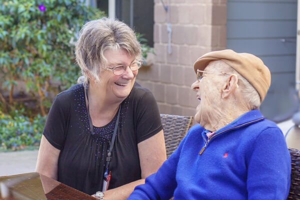 Senior laughing with carer