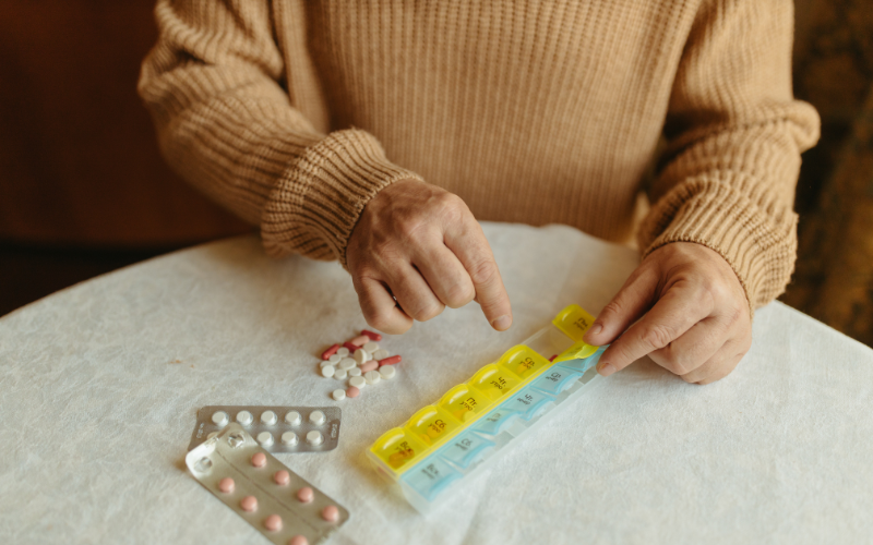 Photo of an elderly person with their medications