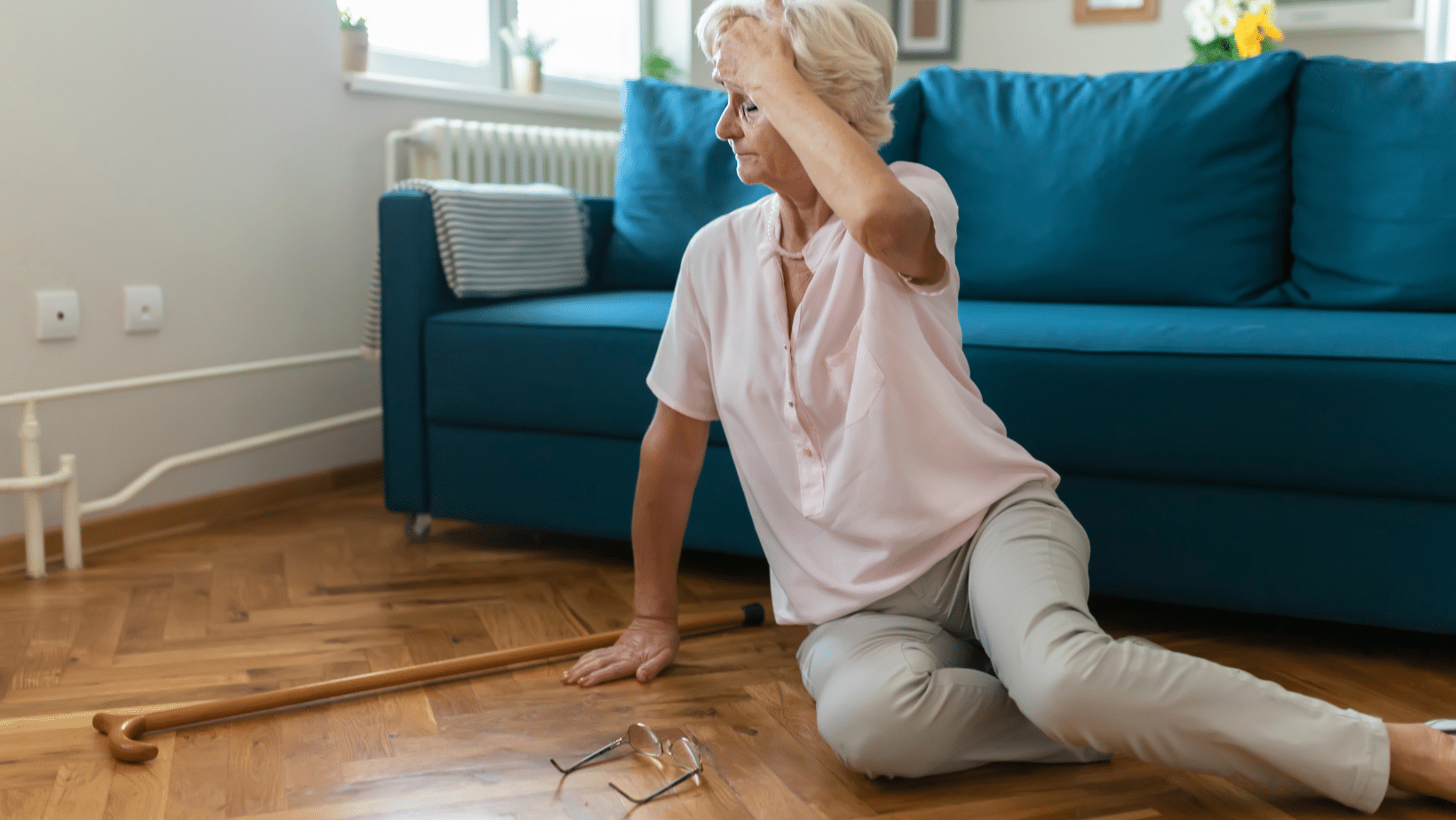 Female senior on the floor scratching head after falling