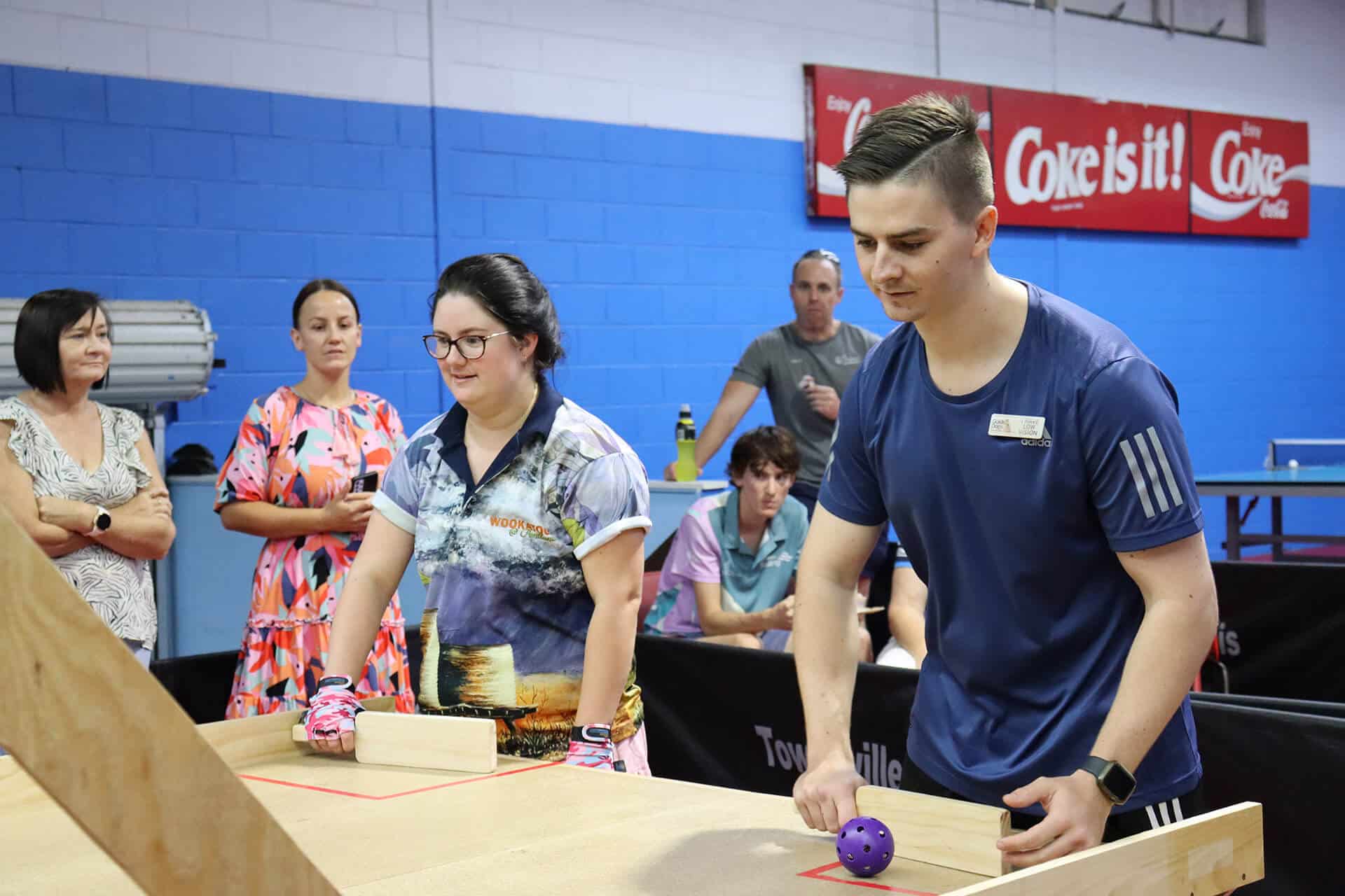 2 people playing a game of modified table tennis for vision impaired people, known as Swish.