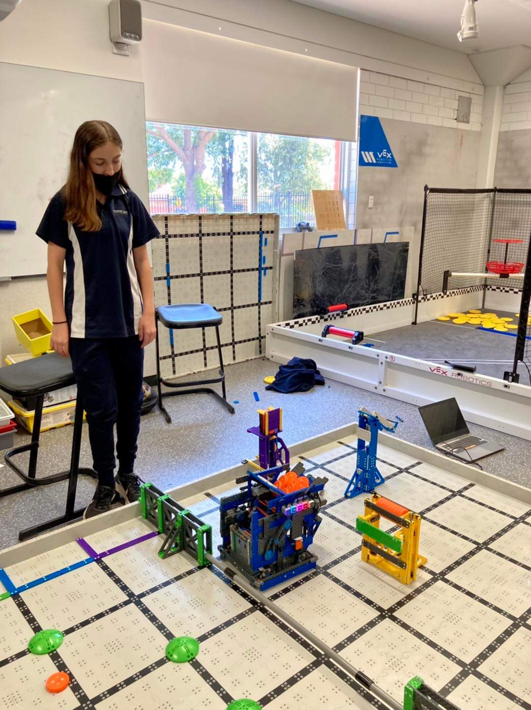 Photo of Amelia looking down at robotics project
