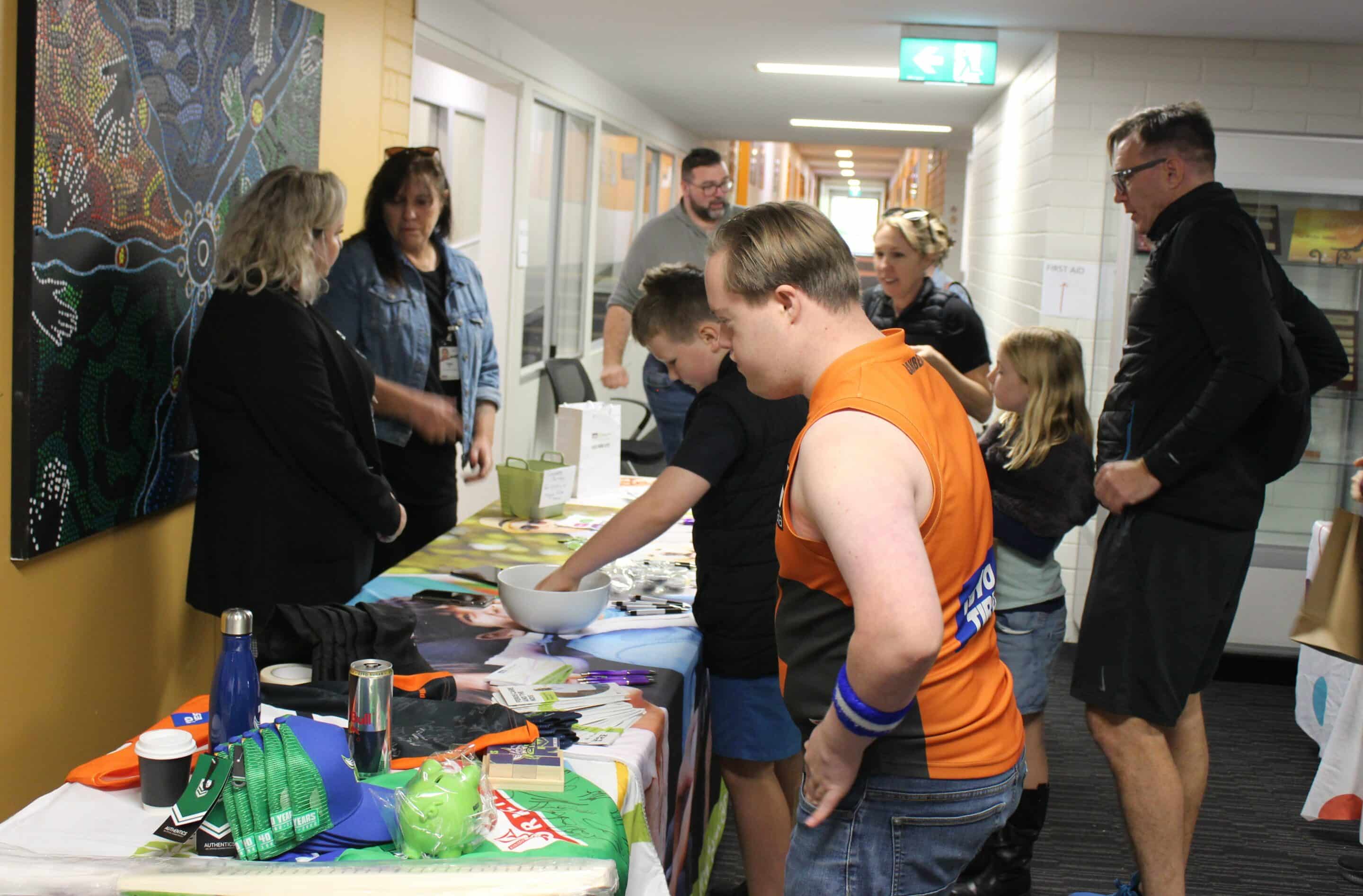 Attendees inside visiting a stallholder at the All Abilities Sports and Recreation Expo