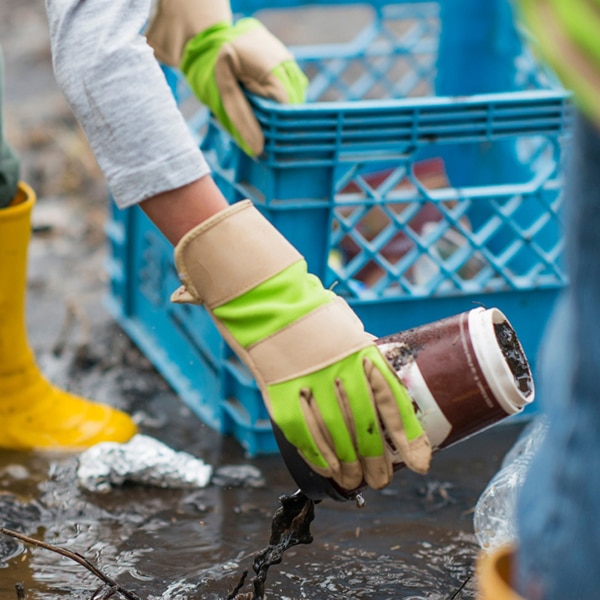 Photo of hand picking up disposable cup with mud pouring out