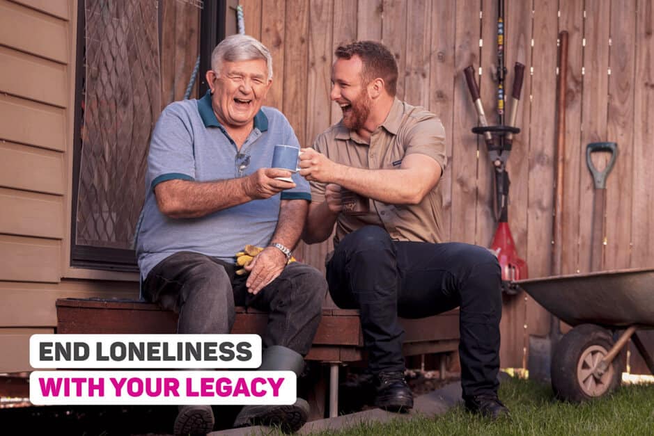 End loneliness with your legacy Photo of a younger man with male senior laughing together. Text on top of photo which says End loneliness with your legacy