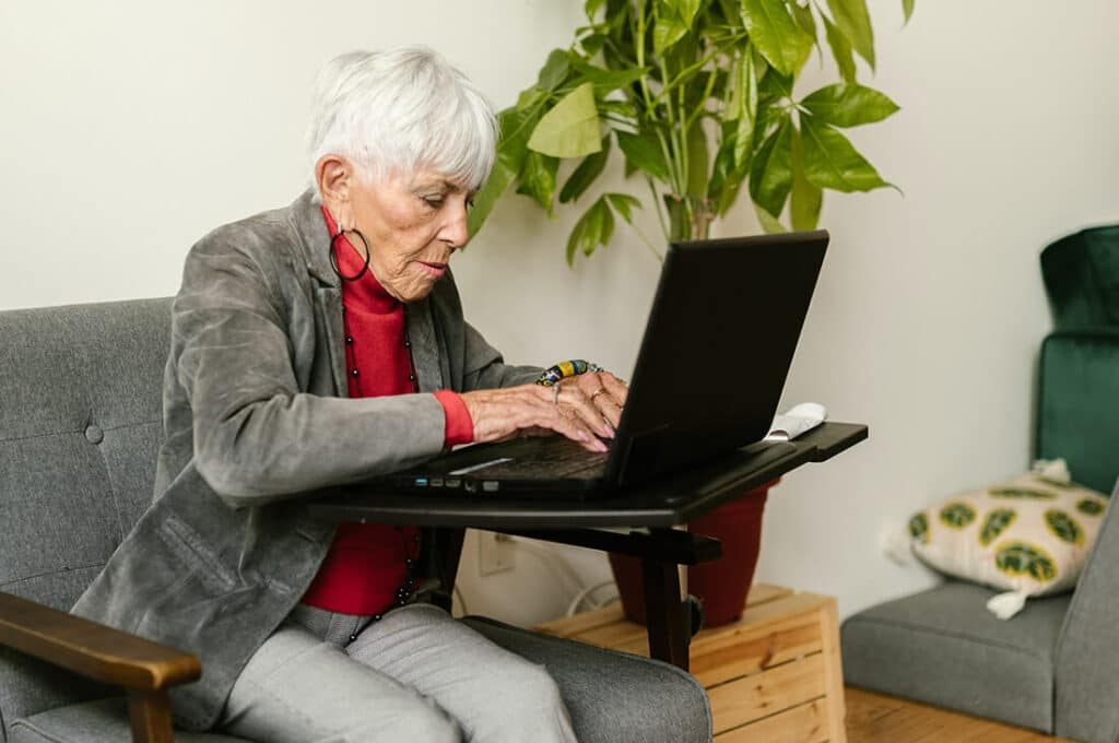 Photo of senior woman using laptop