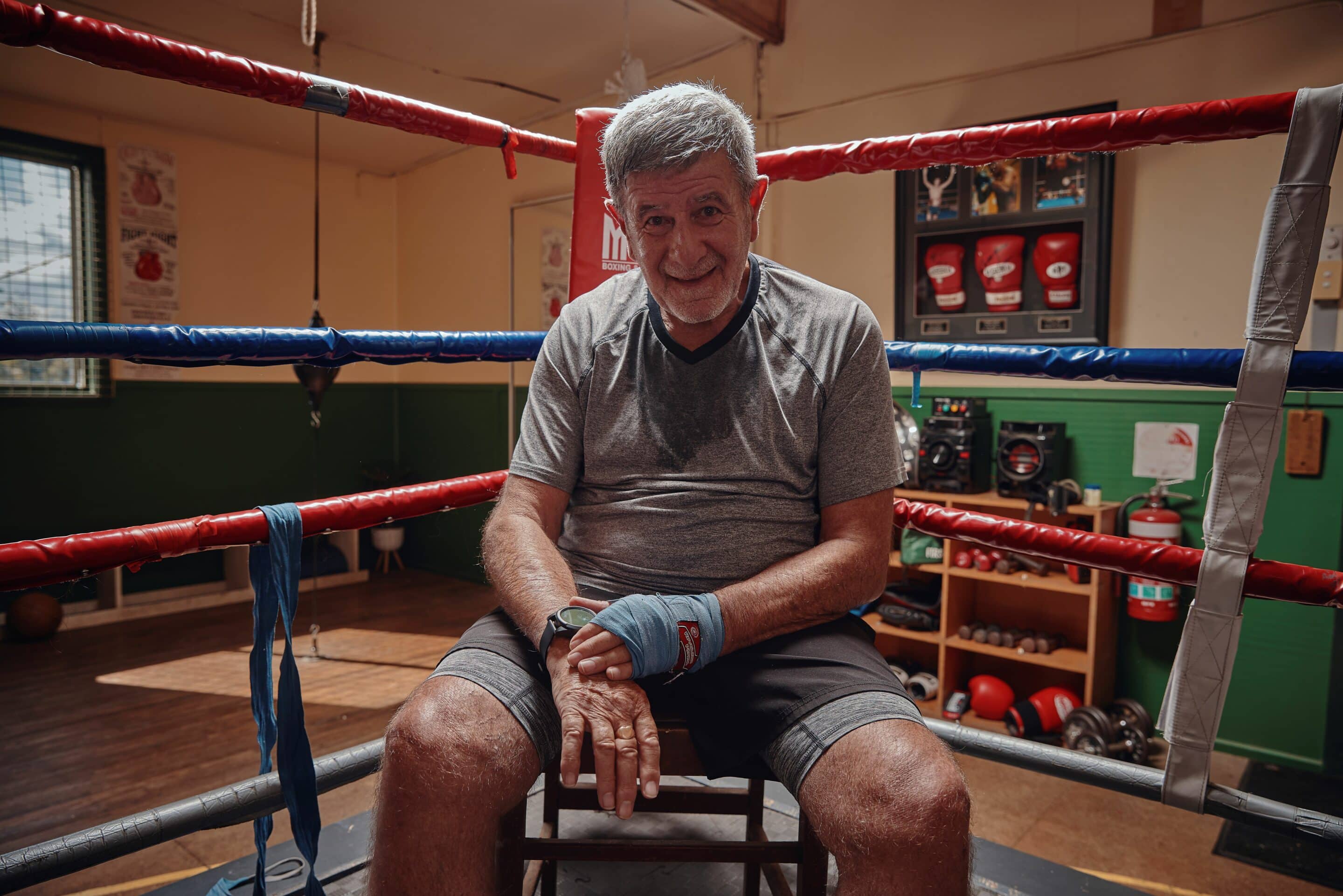 Feros Care client Darryl Ferney sitting in a boxing ring
