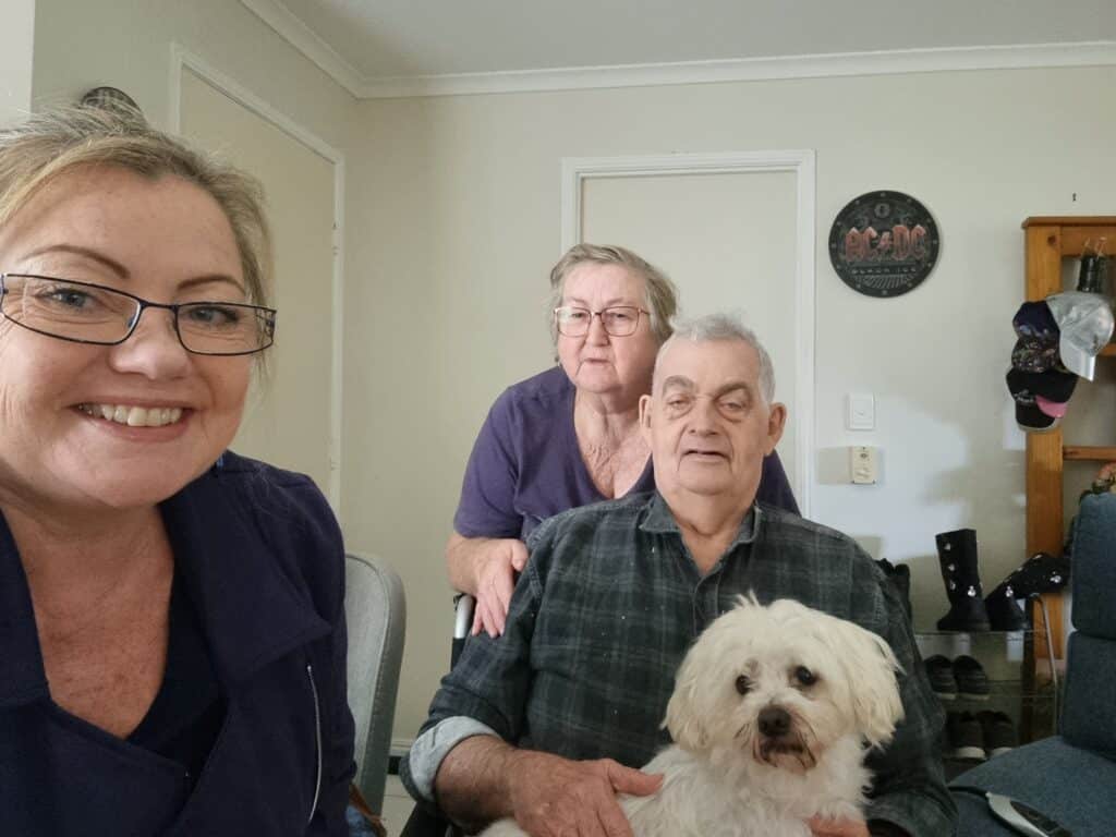 Feros Care Home Care Package clients Clare and Graham with their Wellbeing Manager Nicola and pet dog, Duke.