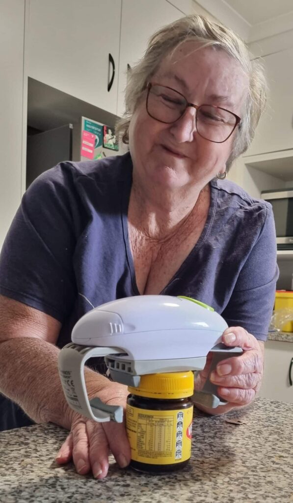 Clare using her one touch jar opener to open a jar of vegemite