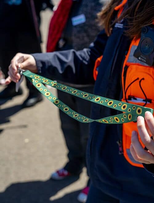 Photo of person holding a sunflower lanyard