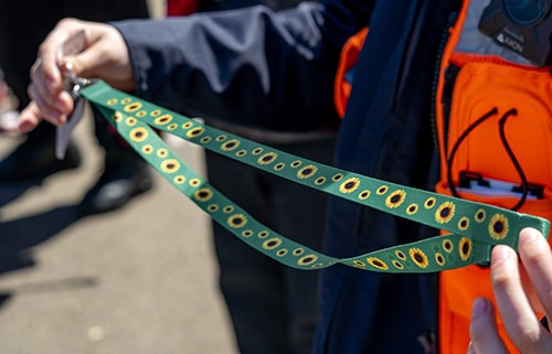 Photo of person holding a sunflower lanyard
