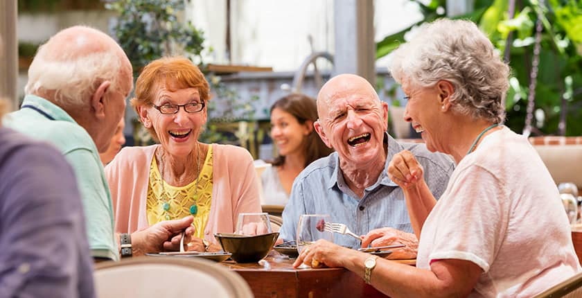 Clients laughing while eating lunch at a cafe