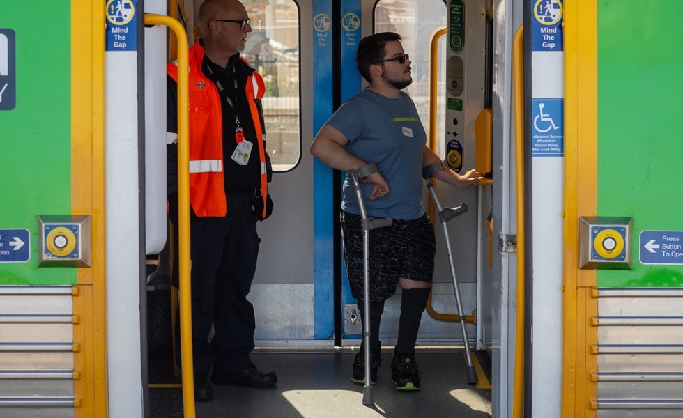 man with disability on train with train driver
