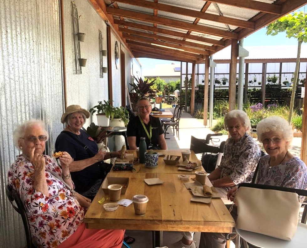 A happy group of Feros Care Social Group participants enjoying a lovely lunch during a recent Summerland trip.