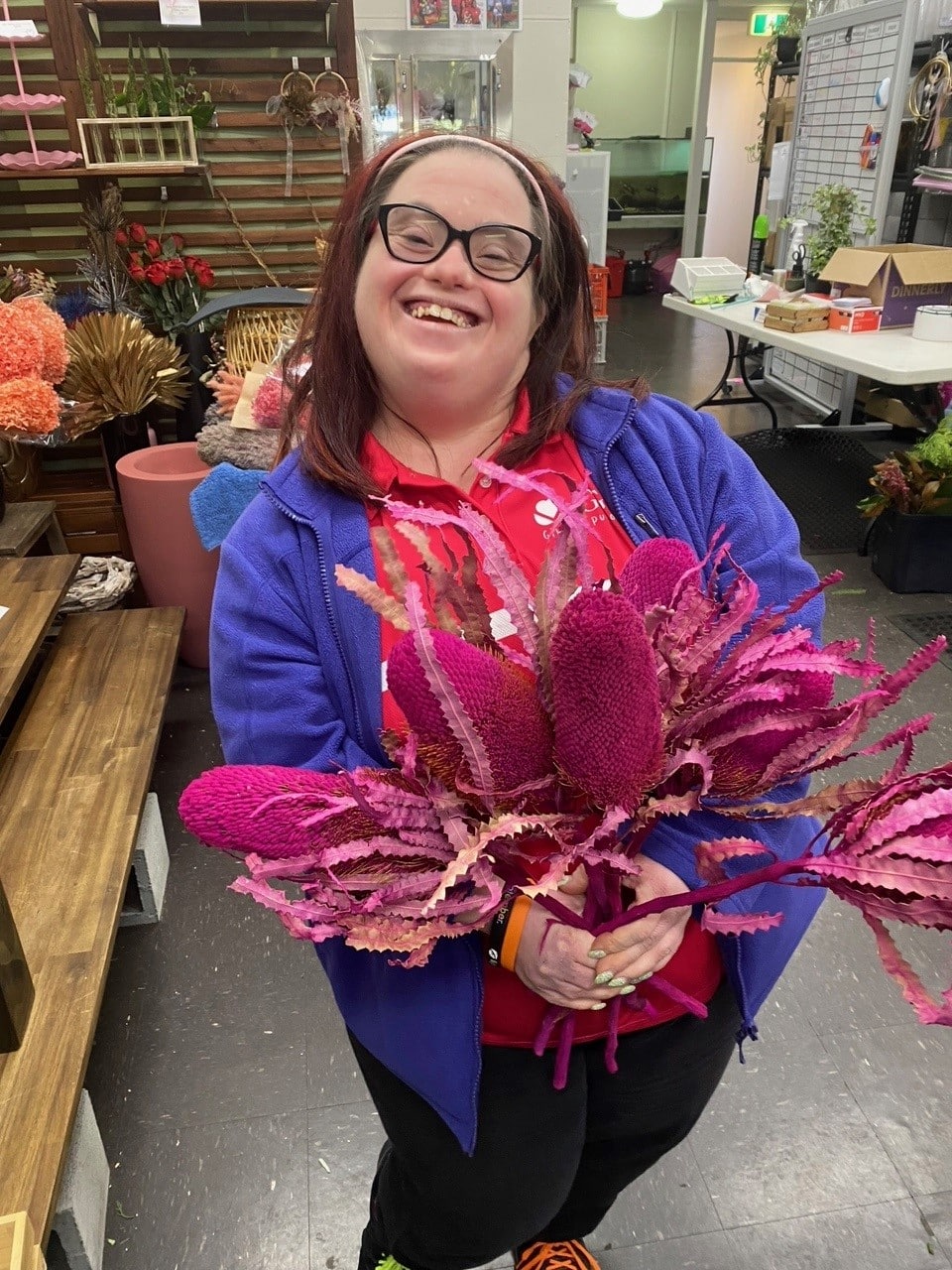 Woman with Down syndrome holding a bunch of flowers