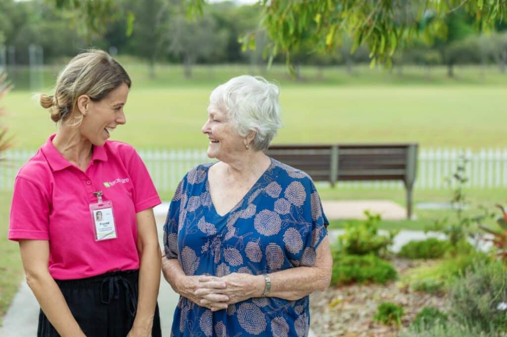 Feros Care Wommin Bay Residential Village Lifestyle Coordinator Crystal laughing with resident Berryl