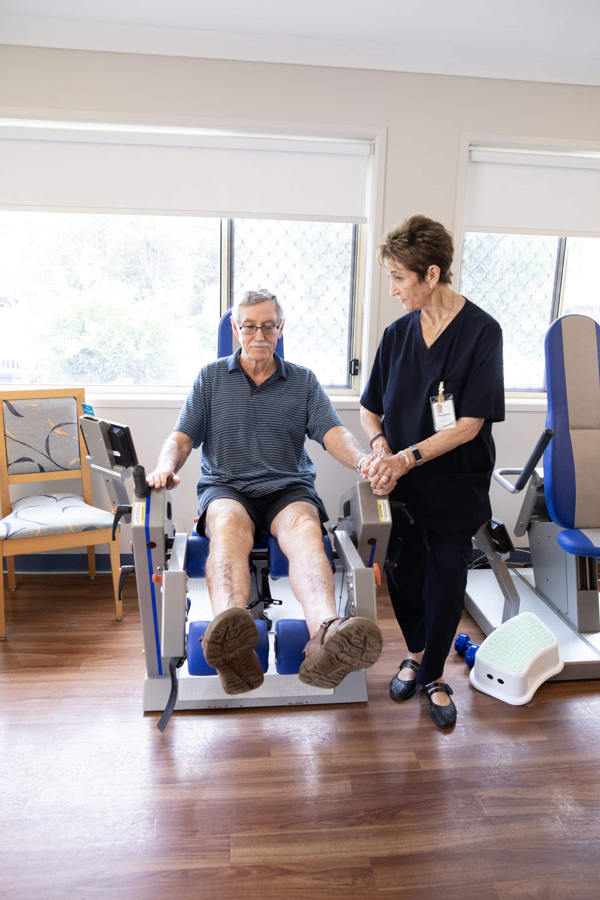 man doing exercises with physiotherapist at Feros Care Wommin Bay village for aged care.