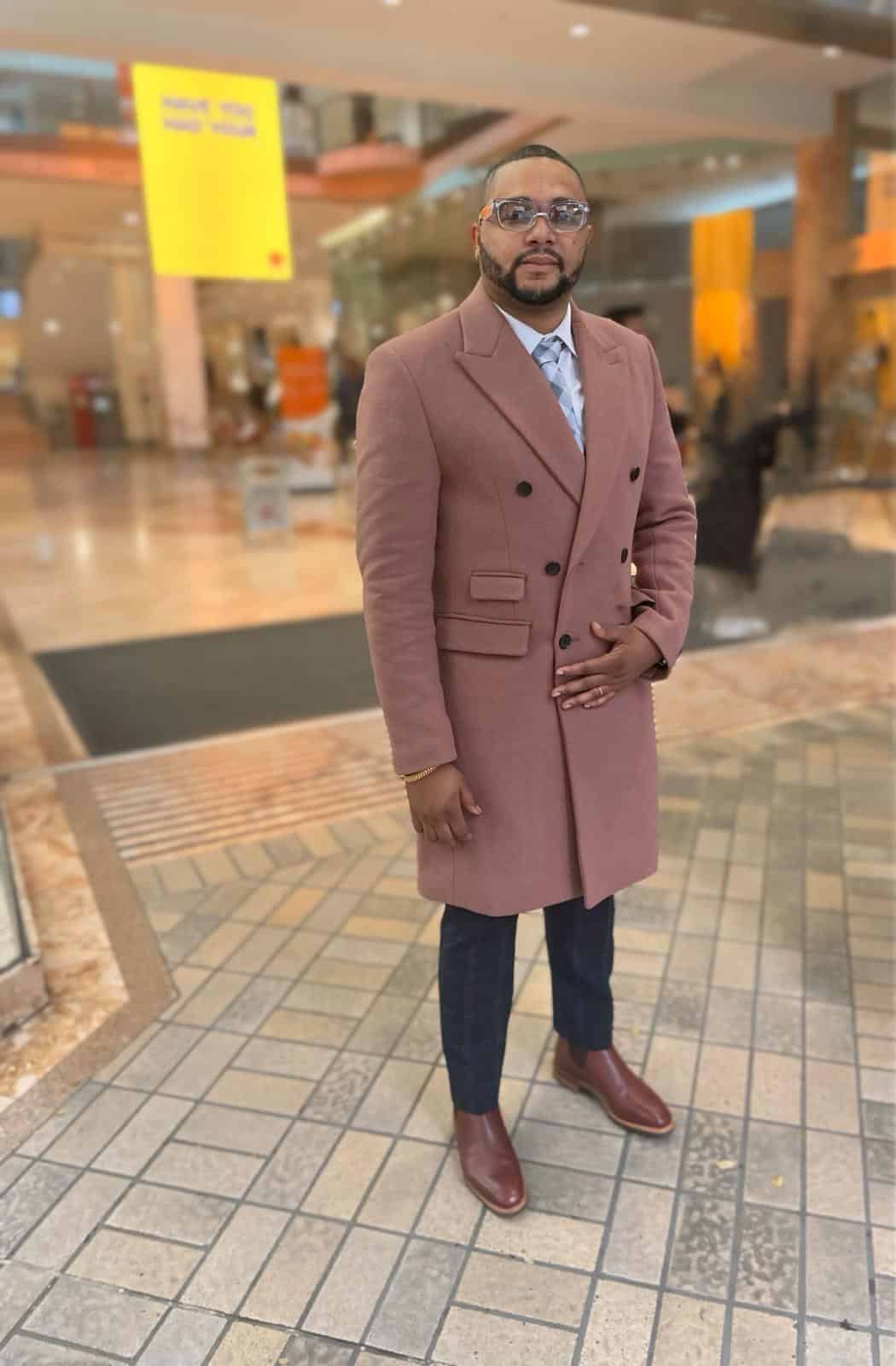 young black man in stylish coat