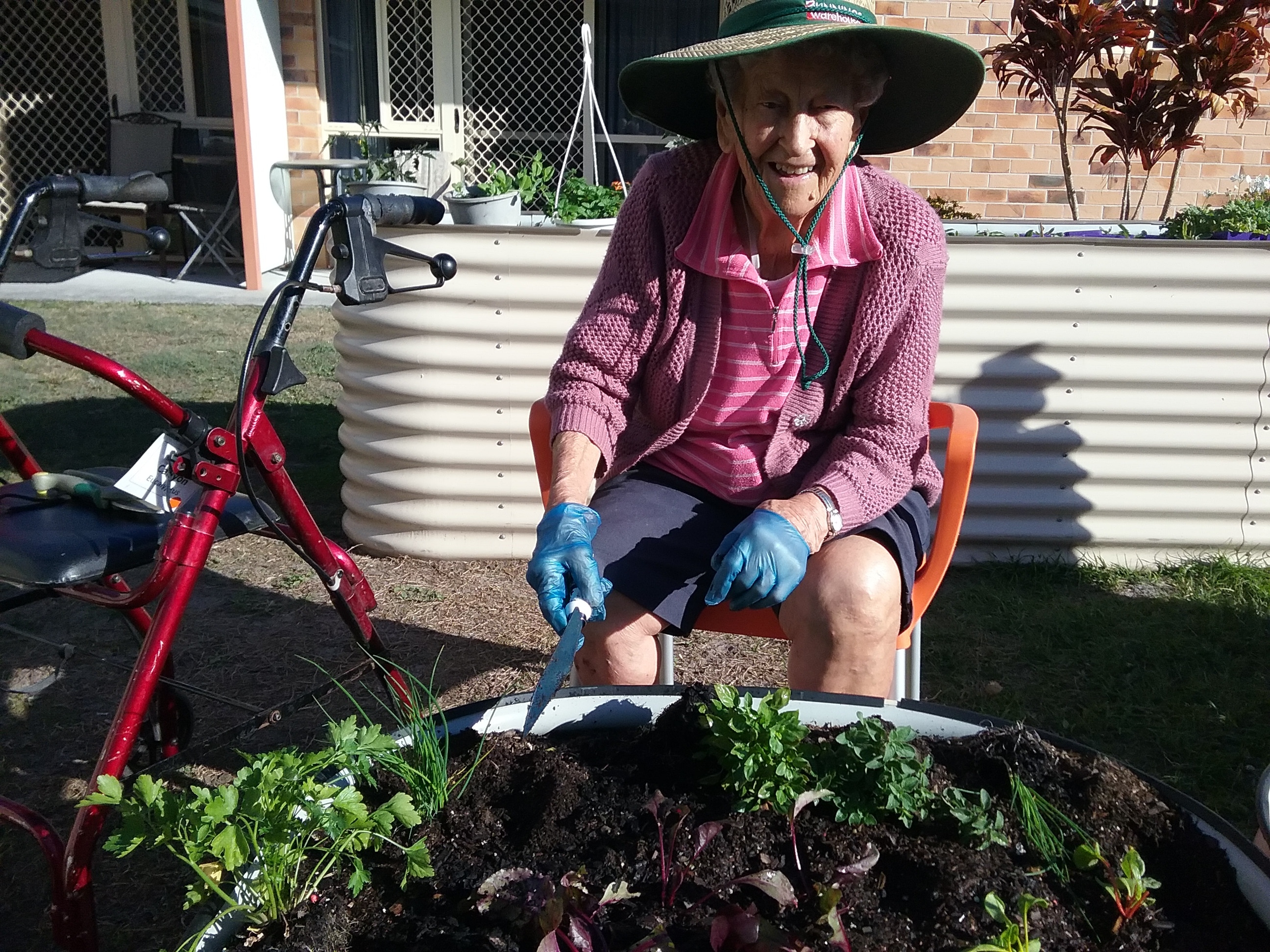 aged care resident gardening at Wommin Bay Village